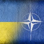 Ukrainian and NATO flag on concrete
