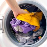 man's hand Pick up clothes Washing machine.Clean and Healthy Concepts