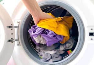 man's hand Pick up clothes Washing machine.Clean and Healthy Concepts