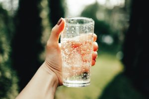 Woman's hand holds a glass of water